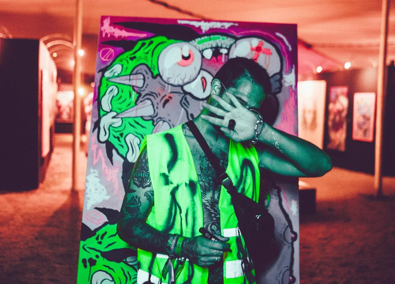 artist Binau during a live painting session at Boom Festival 2023, curated by Because Art Matters.