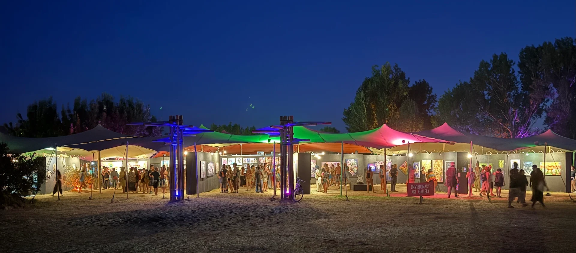 General view of the Envisionary Art Gallery during Boom Festival 2025, a bustling hub for visionary and psychedelic art curated and produced by Gonçalo Magalhães the founder and curator of Because Art Matters